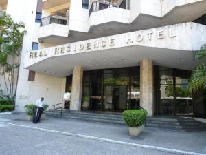 un homme debout devant un hôtel dans l'établissement Apart-Hotel Praia de Copacabana, à Rio de Janeiro