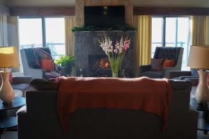 a living room with a couch and a fireplace at Cedar Lodges Resort and Residences Galiyat in Chhāngla Gali