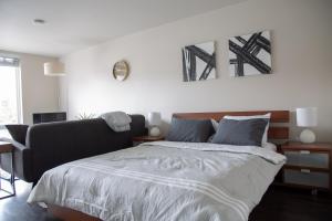 a bedroom with a large bed in a room at Capitol Hill Modern Studio with Free Parking! in Seattle