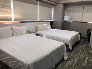 Postel nebo postele na pokoji v ubytování 藝築文旅-昆明館Artinn Kunming