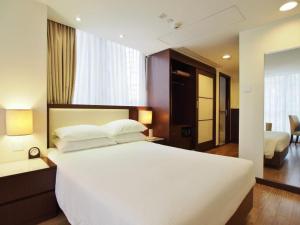 a bedroom with a large white bed in a room at 218 Apartment in Hong Kong