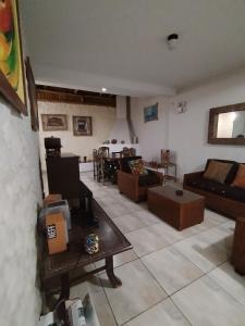 a living room with a couch and a table at Casa BBb Punta Hermosa Planicie in Punta Hermosa