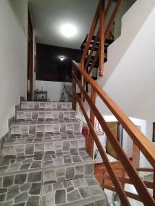 a set of stairs in a house with a stone floor at Casa BBb Punta Hermosa Planicie in Punta Hermosa