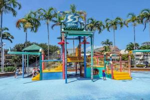 a playground at a resort with people playing on it at NEW! 2BR Beachside Boutique Living in Townsville in Townsville