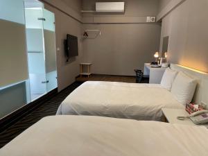 Postel nebo postele na pokoji v ubytování 藝築文旅-昆明館Artinn Kunming