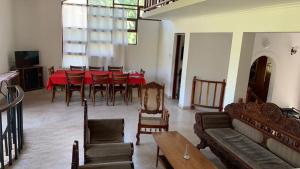 a living room with a red table and chairs at Bellevue Retreat in Kandy