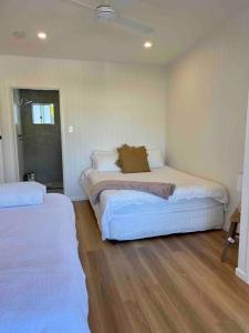 een slaapkamer met 2 bedden in een kamer bij Studio 2 Boreen Point Boutique Accommodation in Cootharaba
