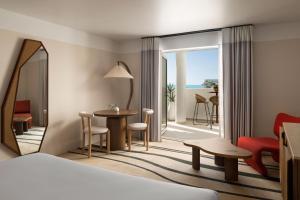 a hotel room with a bed and a view of the ocean at Sandbourne Santa Monica, Autograph Collection in Los Angeles