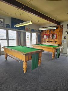 two ping pong tables in a room with at The Pelorus Tavern in Havelock