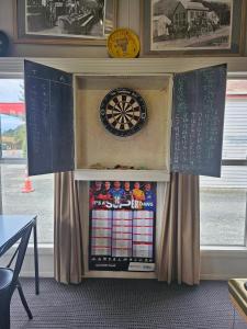 a dart board in a cabinet with a dartboard at The Pelorus Tavern in Havelock