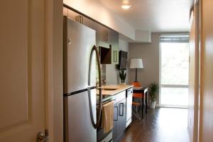 a kitchen with a white refrigerator in a room at Amazing Capitol Hill Apartment with Free Parking! in Seattle