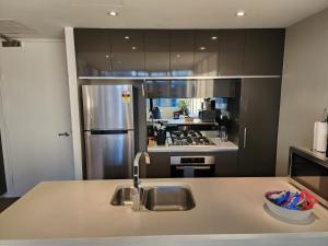 a kitchen with a sink and a refrigerator at Lakefront Views on the foreshore in Kingston 