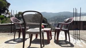 two chairs and a table on top of a roof at Shalom View Homestay in Kandy