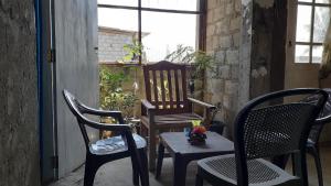 a porch with two chairs and a table at Shalom View Homestay in Kandy