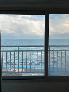 a view of the ocean from a window at Jinistay #Netflix #Oceanview #private barbeque facility #1pm checkout in Ulsan