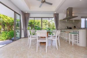 a kitchen and dining room with a table and chairs at Lakeview Pool Villa Near Beautiful Beach VCS1 in Phuket Town