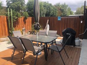 a table and chairs on a patio with a fence at #5 on Blenheim St in Renwick