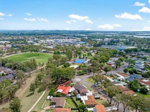 an aerial view of a town with houses and trees at Discover Mount Annan - Spacious 6-BR House in Narellan