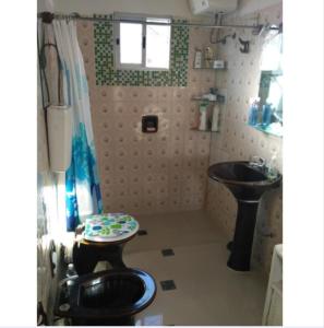 a small bathroom with a toilet and a sink at Lo de Sandra in Costa Azul