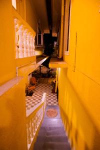 an empty hallway of a building with yellow walls at Primavera Holiday Homes in Candolim