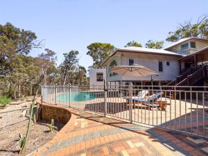 a house with a fence around a swimming pool at Nature's Doorstep - Redgate Beach NEW in Margaret River Town