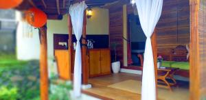 a view of a room with a bedroom and a table at Lafyu Bali in Singaraja