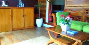 a living room with a green couch and a coffee table at Lafyu Bali in Singaraja