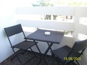 a small table and two chairs on a balcony at Jomtien Condotel Condominium in Pattaya South +15 photos