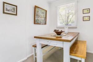 a white desk in a room with a window at Lavender Cottage Leura in Leura
