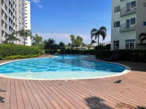 a large swimming pool in the middle of a building at Bright & Breezy 2 BR Unit with Balcony in Manila