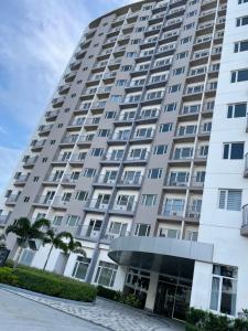 a large white building with a lot of windows at Bright & Breezy 2 BR Unit with Balcony in Manila