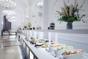 a buffet line with bowls of food on it at Hotel Сomplex Irtysh in Pavlodar