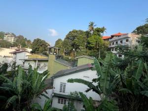 a group of buildings in a city with trees at Bellevue Retreat in Kandy