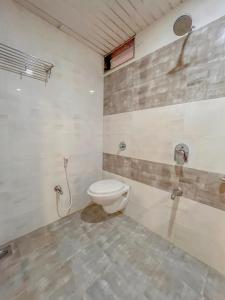 a bathroom with a toilet and a shower at Park View Residency in Bhuj