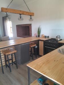 a kitchen with wooden counter tops and a stove at Vischgat farm guest house in Loxton