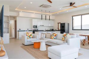 a living room with white furniture and a kitchen at Modern Villa Walking Distance to Fisherman Village KBR15 in Amphoe Koksamui