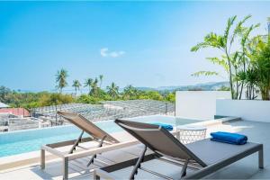a patio with a table and chairs next to a swimming pool at Modern Villa Walking Distance to Fisherman Village KBR15 in Amphoe Koksamui