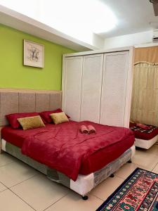 a bedroom with a large red bed in a room at Private Studio Viana Court Service Apartment 3 with private parking in Kota Bharu