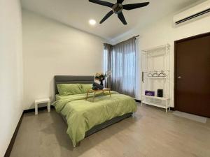 a bedroom with a bed with a ceiling fan at 10 Pax-Cozy Family Suite Landmark 2 in Kajang