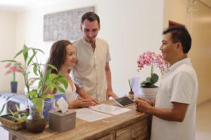a group of three people standing around a table at Alam Canggu Kuta by ABM in Canggu +56 photos