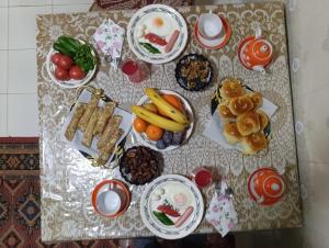 a table topped with plates of food on a table at Al-Bashir in Bukhara