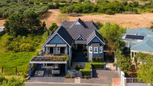an aerial view of a house with a blue house at Mont Vue Manor in Franschhoek
