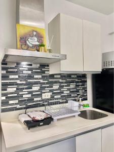 a kitchen with a sink and a counter top at Azure Urban Resort - CITY VIEW 1BR - PS4, Billiards, Netflix, Karaoke in Manila
