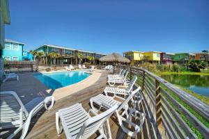 a deck with chairs and a swimming pool at Best Little Shore House by AvantStay Cart Zone in Port Aransas