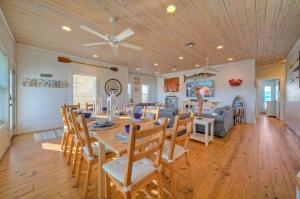 a dining room and living room with a table and chairs at Best Little Shore House by AvantStay Cart Zone in Port Aransas