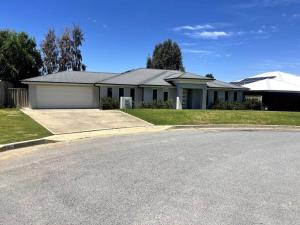 a house with a road in front of it at Stylish Open Plan Retreat in Wagga Wagga