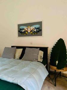 a bedroom with a bed and a picture on the wall at Fika House Galle in Unawatuna