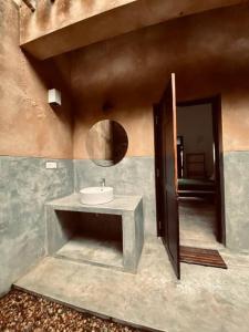 a bathroom with a sink and a mirror at Fika House Galle in Unawatuna