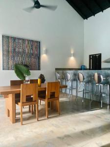 a dining room with a table and chairs at Fika House Galle in Unawatuna