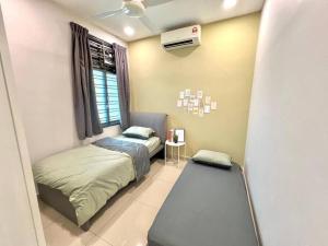 a bedroom with two beds and a window at Mount Austin Retreat in Johor Bahru +9 photos
